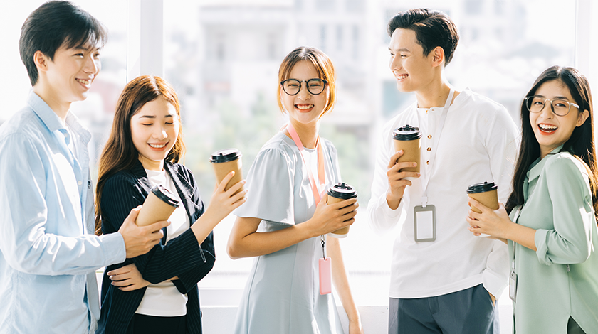 Group of happy employees greeting each other